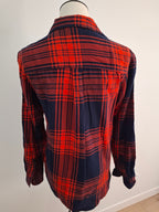 A red and navy blue plaid flannel shirt shown from the back on a mannequin torso.