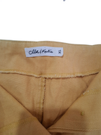 Close-up of a mustard yellow garment showing the inner waistband and a white woven label that reads 'Chloe & Katie' and 'XL'.