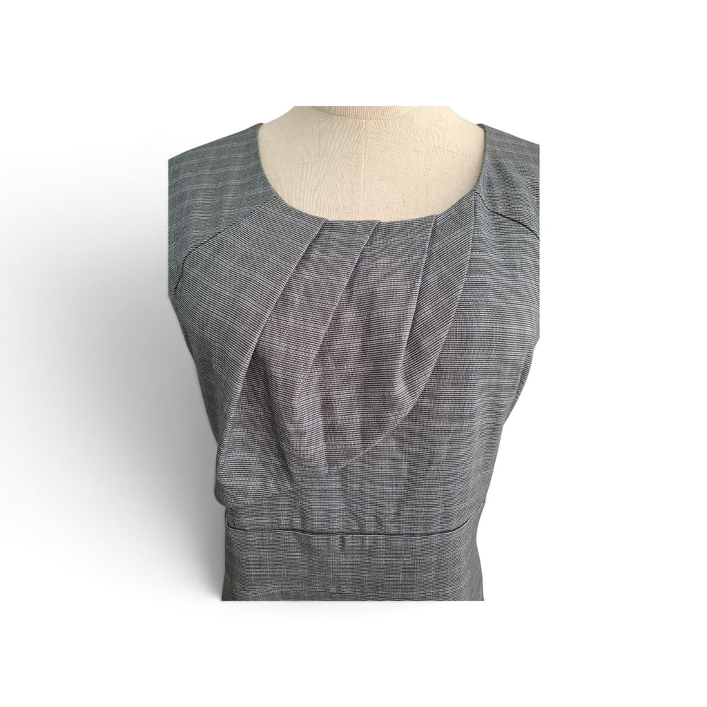 A gray plaid sleeveless top displayed on a beige dress form mannequin against a white background.