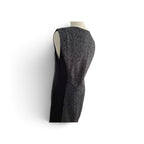 A sleeveless black and gray herringbone tweed vest displayed on a mannequin torso against a plain white background.