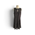 A sleeveless black dress with a small beige leopard print pattern, displayed on a mannequin torso against a white background.