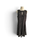 A sleeveless black dress with a small beige leopard print pattern, displayed on a mannequin torso against a white background.