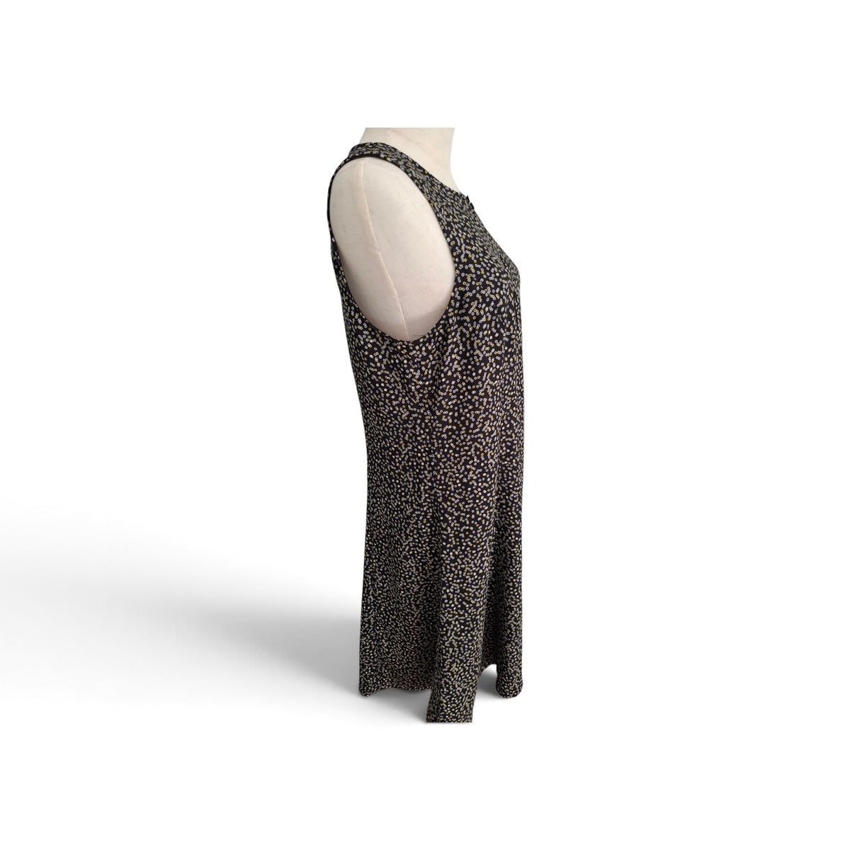 A sleeveless, scoop-neck maxi dress with a small-scale leopard print pattern in black and brown, displayed on a cream-colored mannequin torso against a white background.