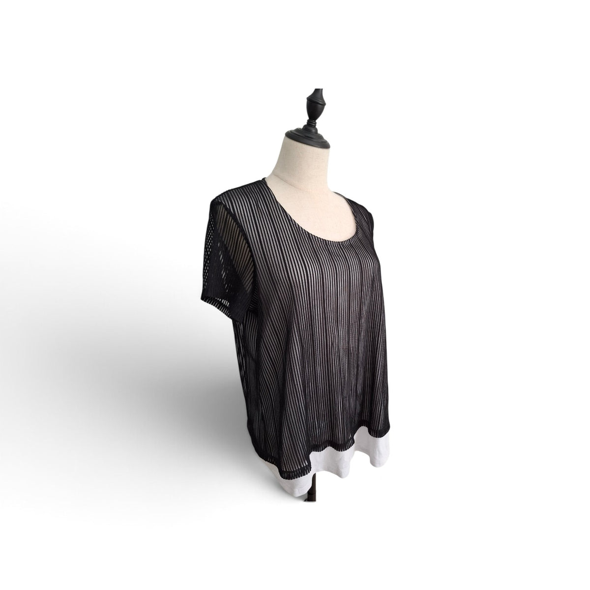 A black sheer mesh top with thin vertical white stripes, displayed on a cream-colored dress form mannequin against a white background.