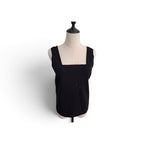 A black sleeveless knit top with a square neckline, displayed on a cream-colored dress form mannequin against a plain white background.