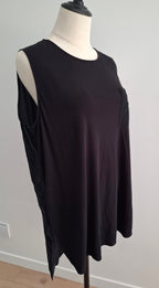 A black sleeveless top displayed on a cream mannequin torso against a plain light gray wall.
