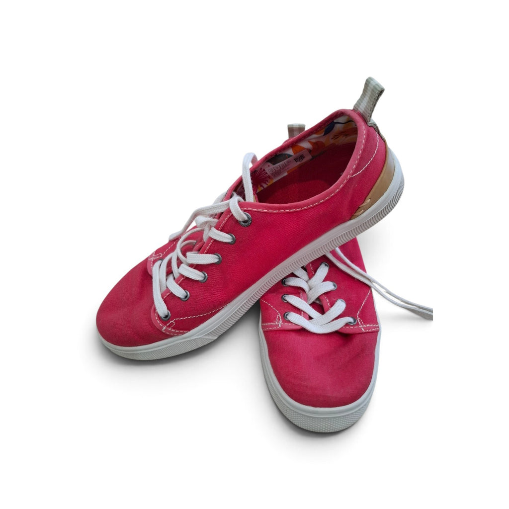 A pair of low-top canvas sneakers in a vibrant pinkish-red hue with white laces and white rubber soles, displayed on a clean white background.