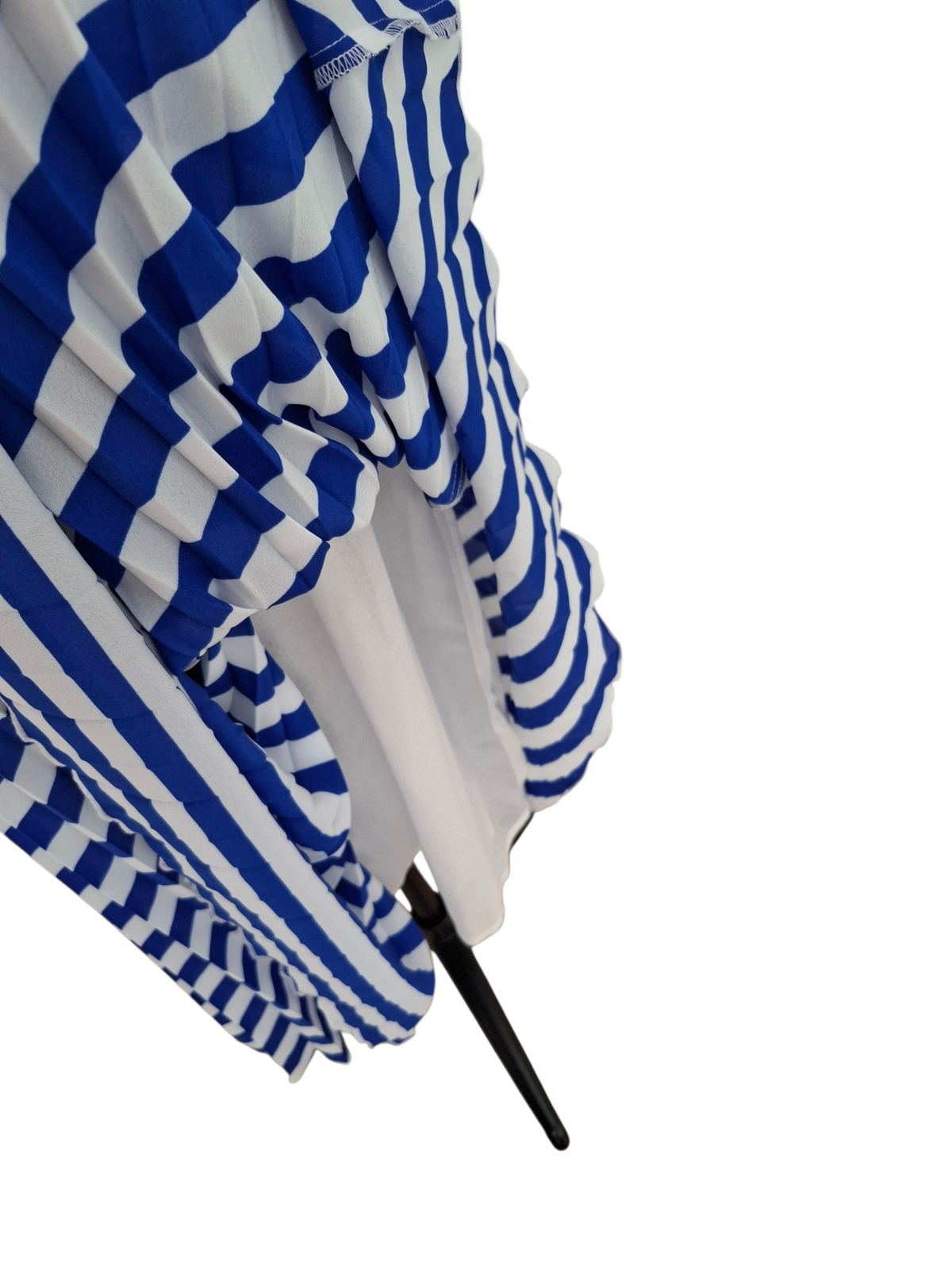 A close-up of a pleated fabric accessory, likely a clutch or small handbag, featuring bold blue and white horizontal stripes with a black handle, set against a plain white background.