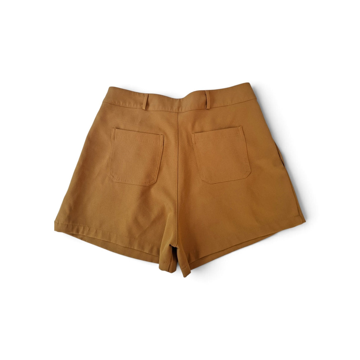 A pair of high-waisted shorts in a warm camel brown color, shown from the back with two large patch pockets, laid flat on a white background.