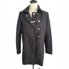 A black double-breasted coat with decorative gold-tone buttons, displayed on a mannequin torso against a plain white background.