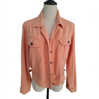 A peach-colored cropped denim jacket with a collar, button front, and two chest flap pockets, displayed on a dress form mannequin against a white background.