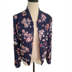A navy blue satin bomber jacket with a pink and white floral print, displayed on a beige dress form mannequin against a white background.
