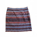 A short A-line skirt featuring a horizontal geometric pattern with blue, purple, brown, and orange diamond and oval motifs on a white background.