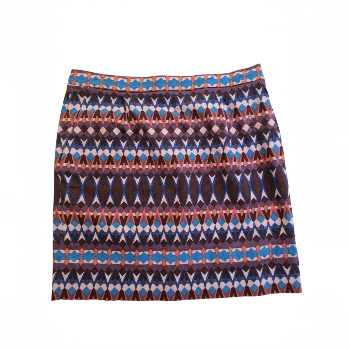 A short A-line skirt featuring a horizontal geometric pattern with blue, purple, brown, and orange diamond and oval motifs on a white background.