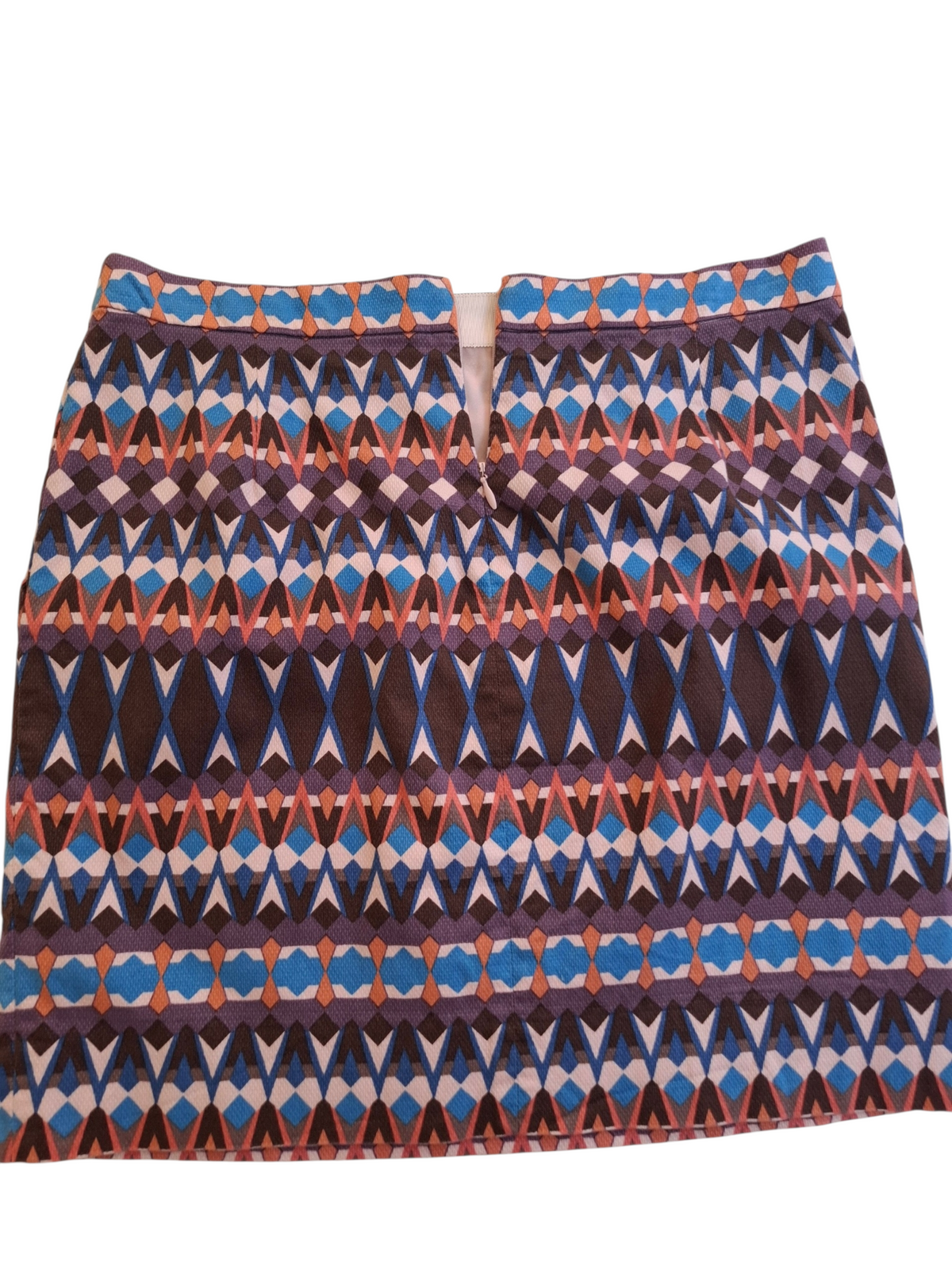 A short A-line skirt with a vibrant geometric ikat pattern featuring blue, purple, brown, and orange on a white background.