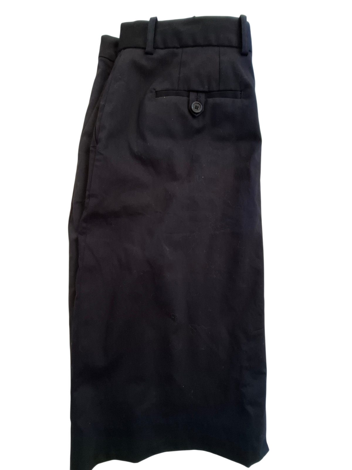 Black dress pants folded to show the back waistband, belt loops, and a buttoned welt pocket, photographed against a plain white background.