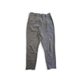 A pair of gray textured trousers laid flat on a white background.