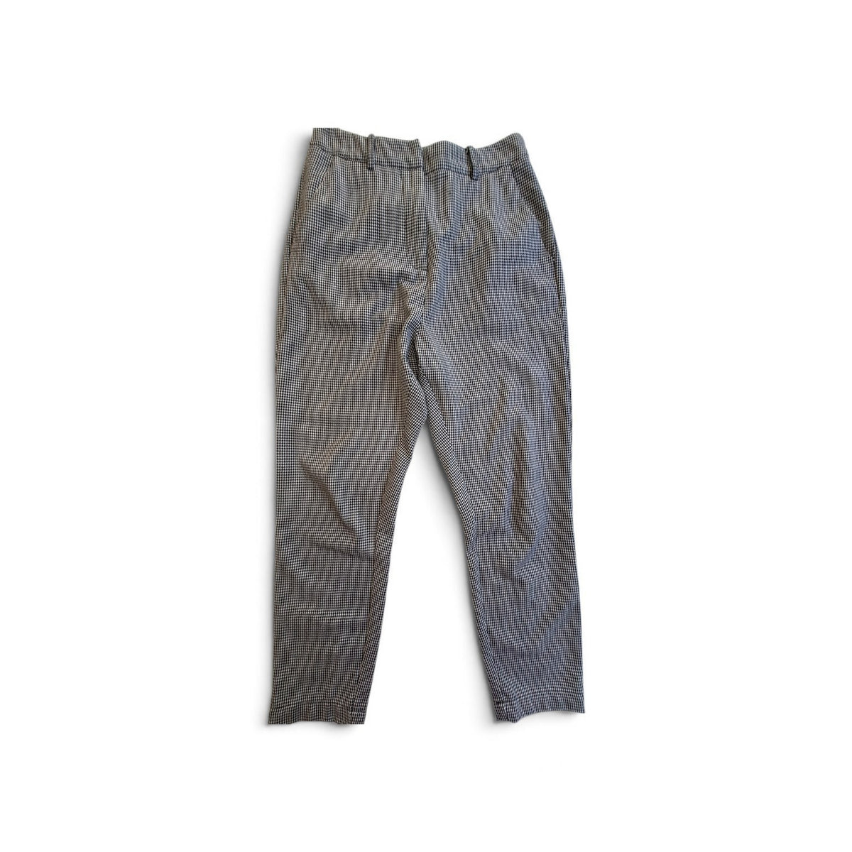 A pair of gray textured trousers laid flat on a white background.