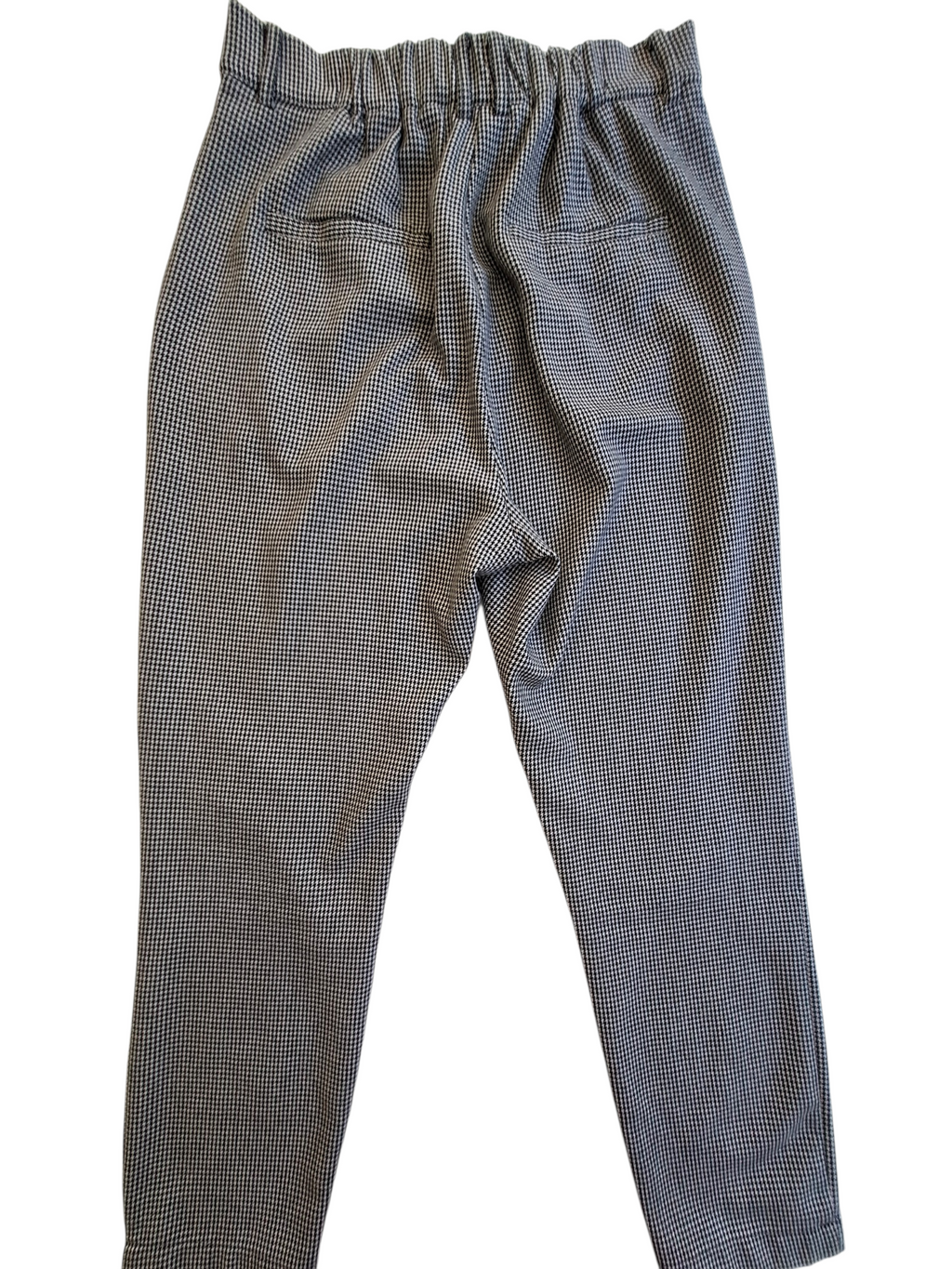 A pair of gray and black micro-check patterned pants with an elastic waistband, photographed flat against a white background.