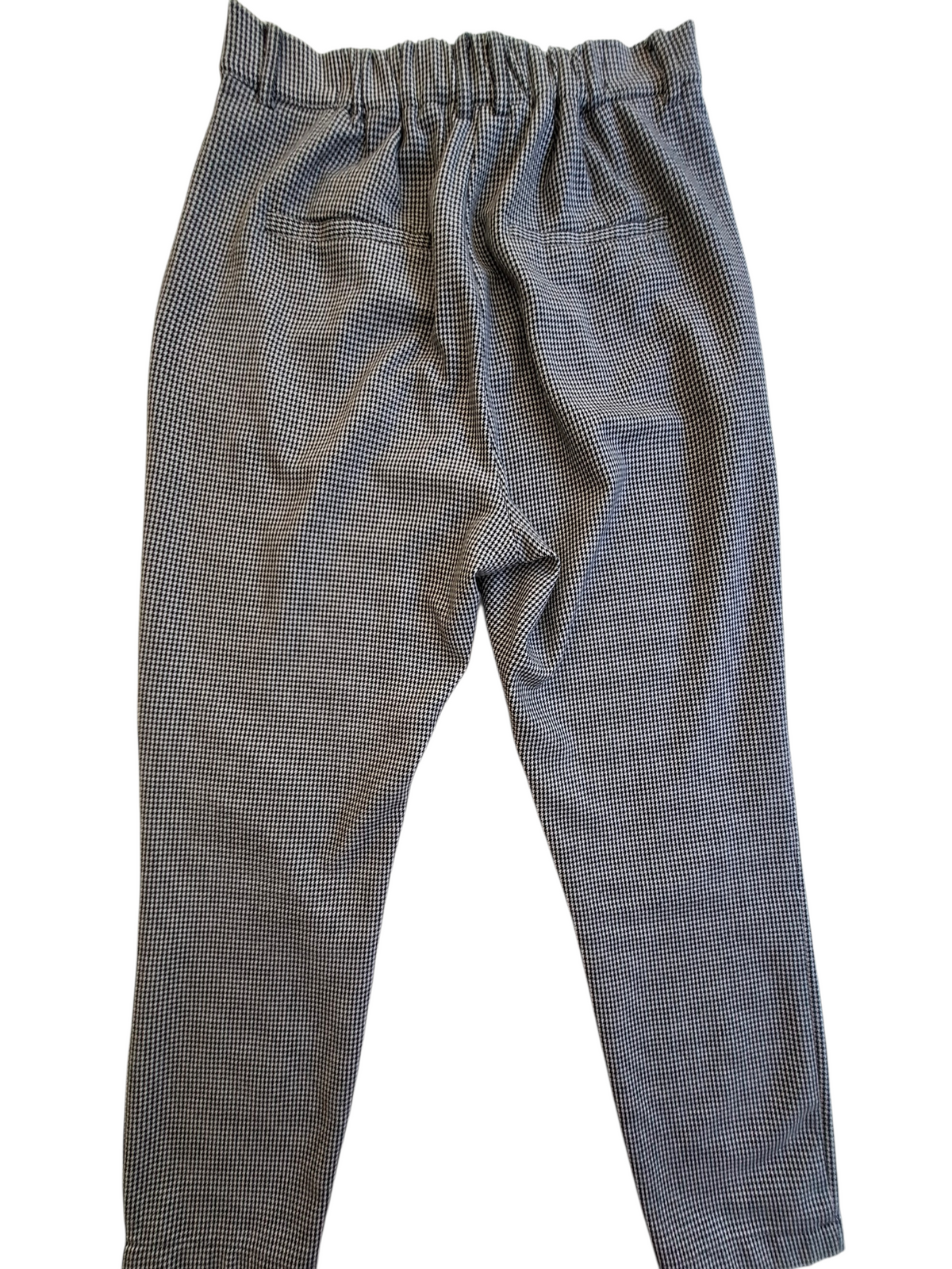 A pair of gray and black micro-check patterned pants with an elastic waistband, photographed flat against a white background.