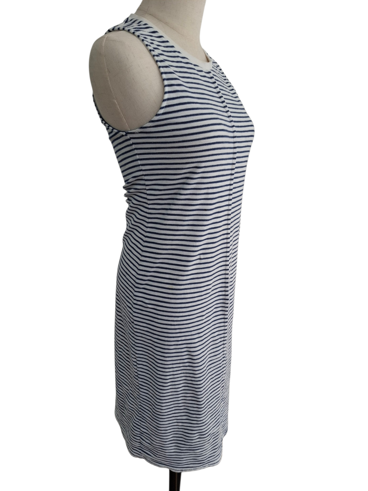 A sleeveless, scoop-neck shift dress with horizontal navy and white stripes, displayed on a beige dress form mannequin against a white background.