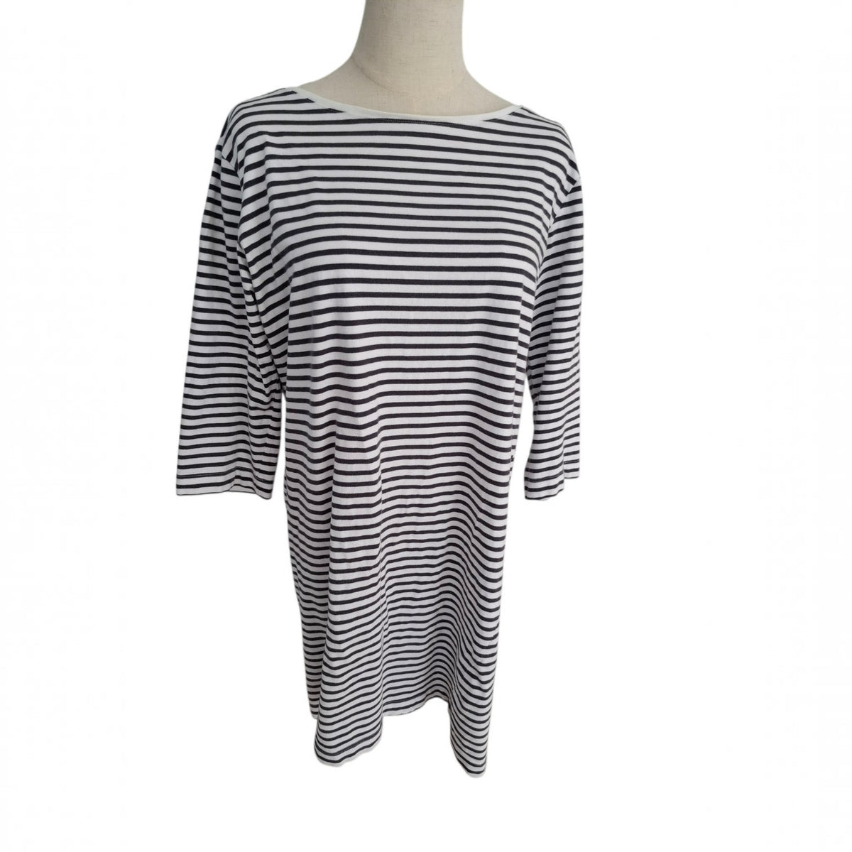 A black and white horizontally striped long-sleeve tunic top displayed on a mannequin torso against a plain white background.