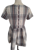 A short-sleeve plaid dress displayed on a mannequin torso, featuring a buttoned back and a gathered waist seam, set against a plain white background.