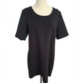 A black short-sleeve tunic top displayed on a cream-colored dress form mannequin against a plain white background.