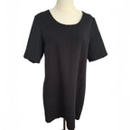 A black short-sleeve tunic top displayed on a cream-colored dress form mannequin against a plain white background.