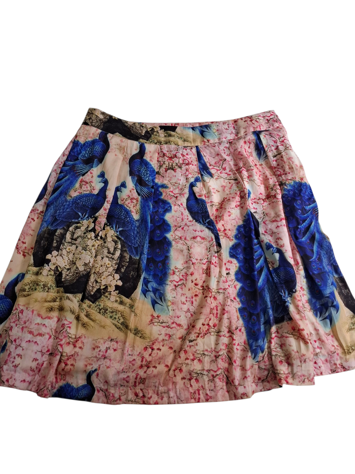 A flared A-line skirt featuring a vibrant print of blue peacocks and pink cherry blossoms on a light beige background.