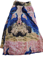 A pleated A-line skirt featuring a vibrant print of blue peacocks, pink cherry blossoms, and a central floral mirror design on a beige background.
