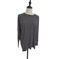A black and white horizontally striped long-sleeve top displayed on a dress form mannequin against a plain white background.