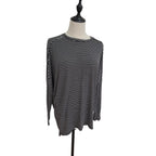 A black and white horizontally striped long-sleeve top displayed on a dress form mannequin against a plain white background.