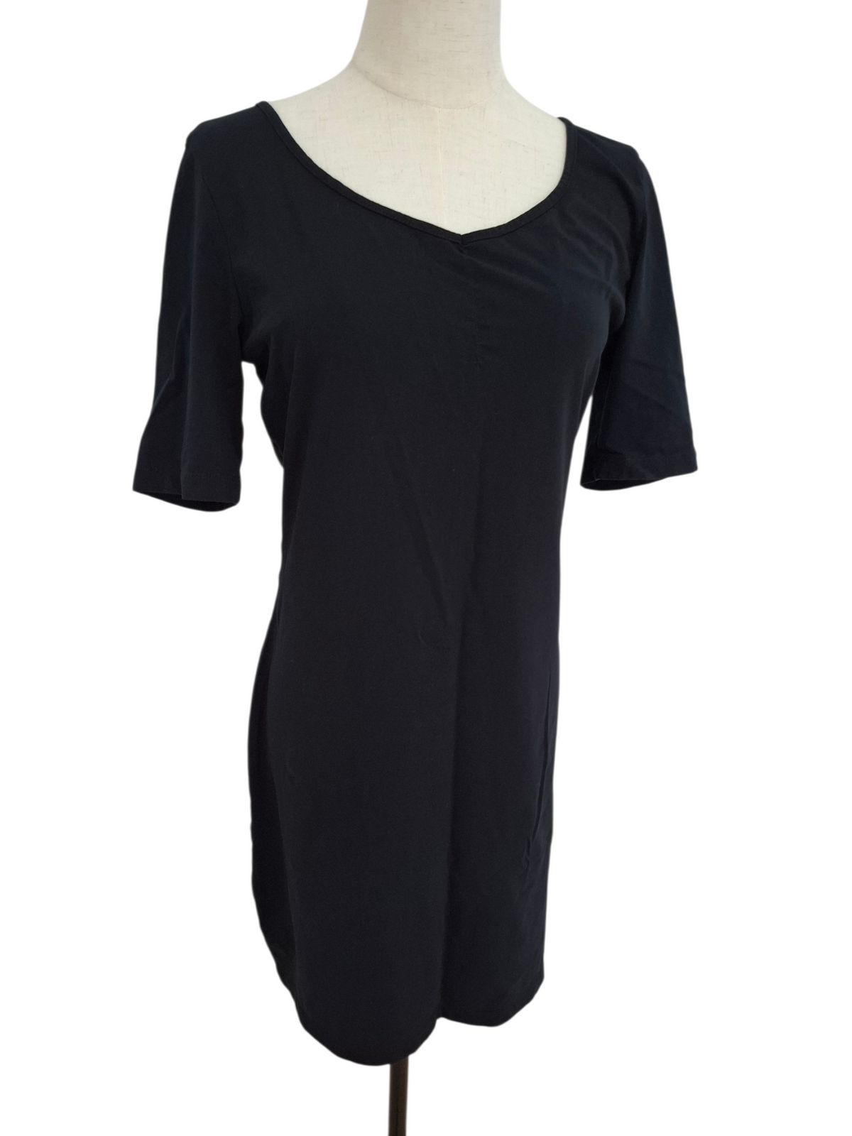 A black short-sleeve shift dress displayed on a cream-colored dress form mannequin against a plain white background.