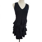A black sleeveless V-neck dress displayed on a mannequin torso against a plain white background. The dress features a tiered ruffle hem.