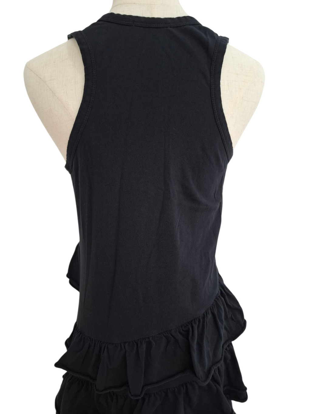 Black sleeveless ruffled top shown from the back on a cream-colored dress form mannequin against a white background.