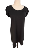 A black short-sleeve top with a scoop neckline, displayed on a mannequin torso against a plain white background.