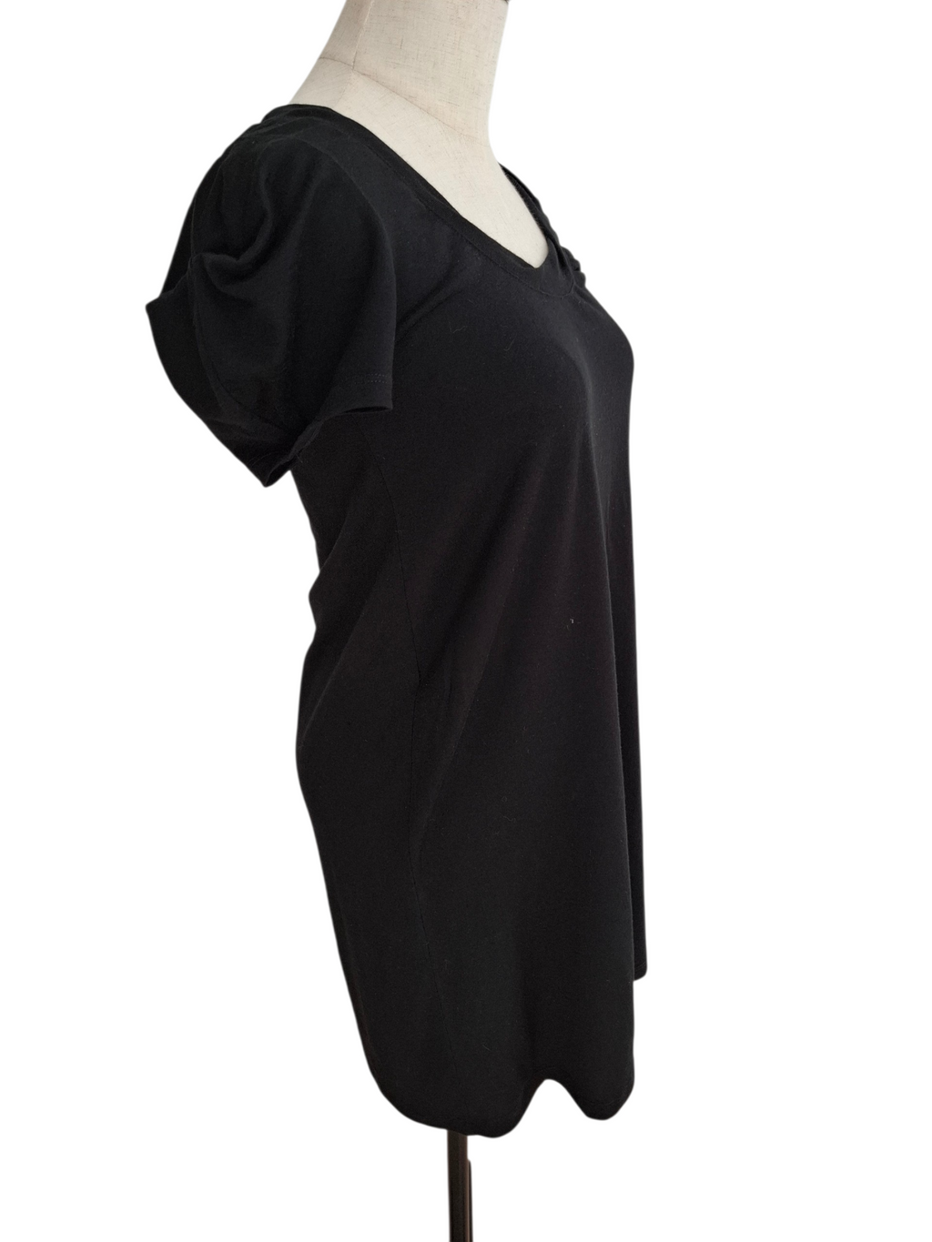 A black short-sleeve V-neck top displayed on a cream mannequin torso against a plain white background.