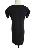 A black short-sleeve t-shirt dress displayed on a cream-colored mannequin torso against a plain white background.