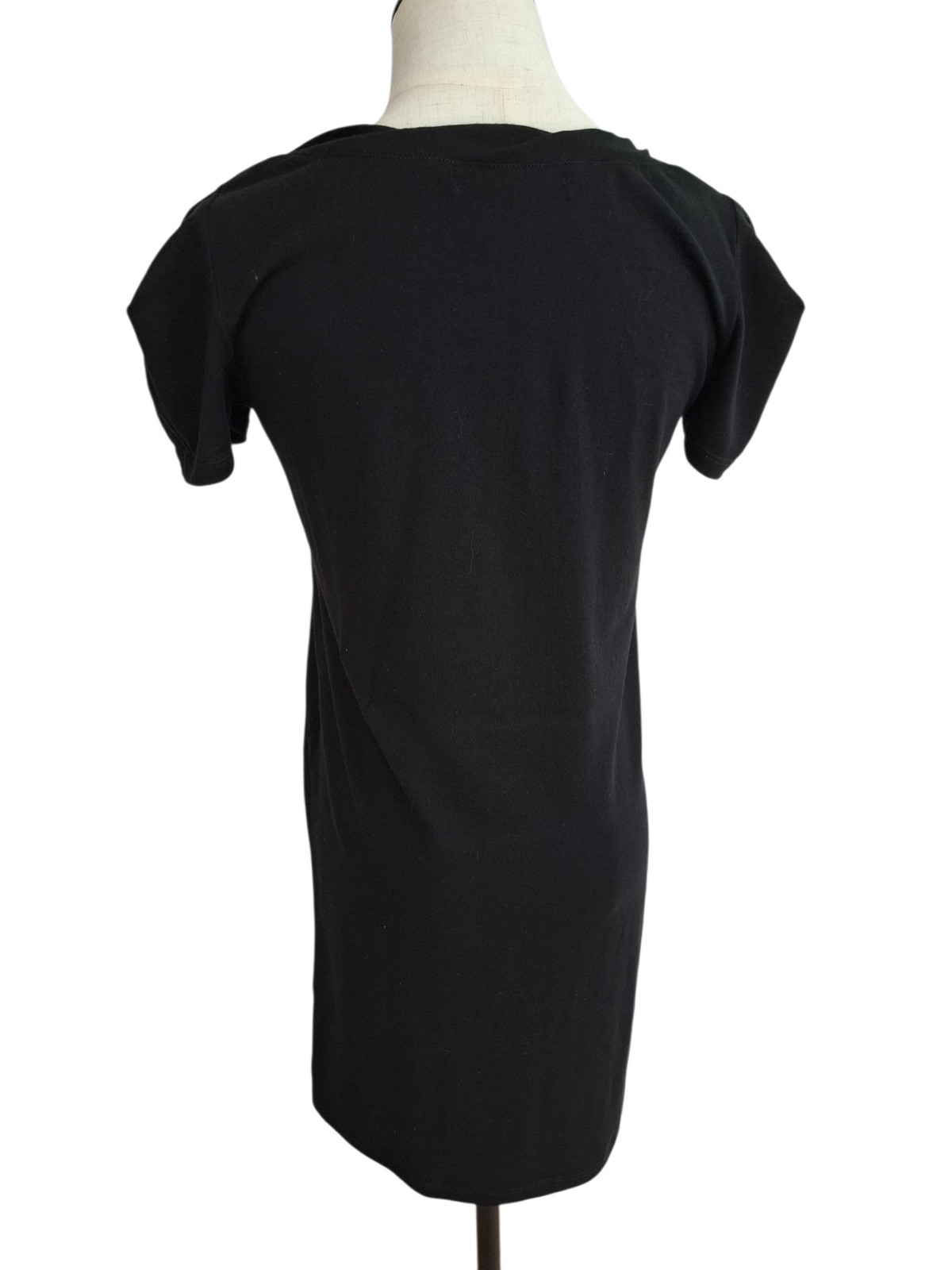 A black short-sleeve t-shirt dress displayed on a cream-colored mannequin torso against a plain white background.