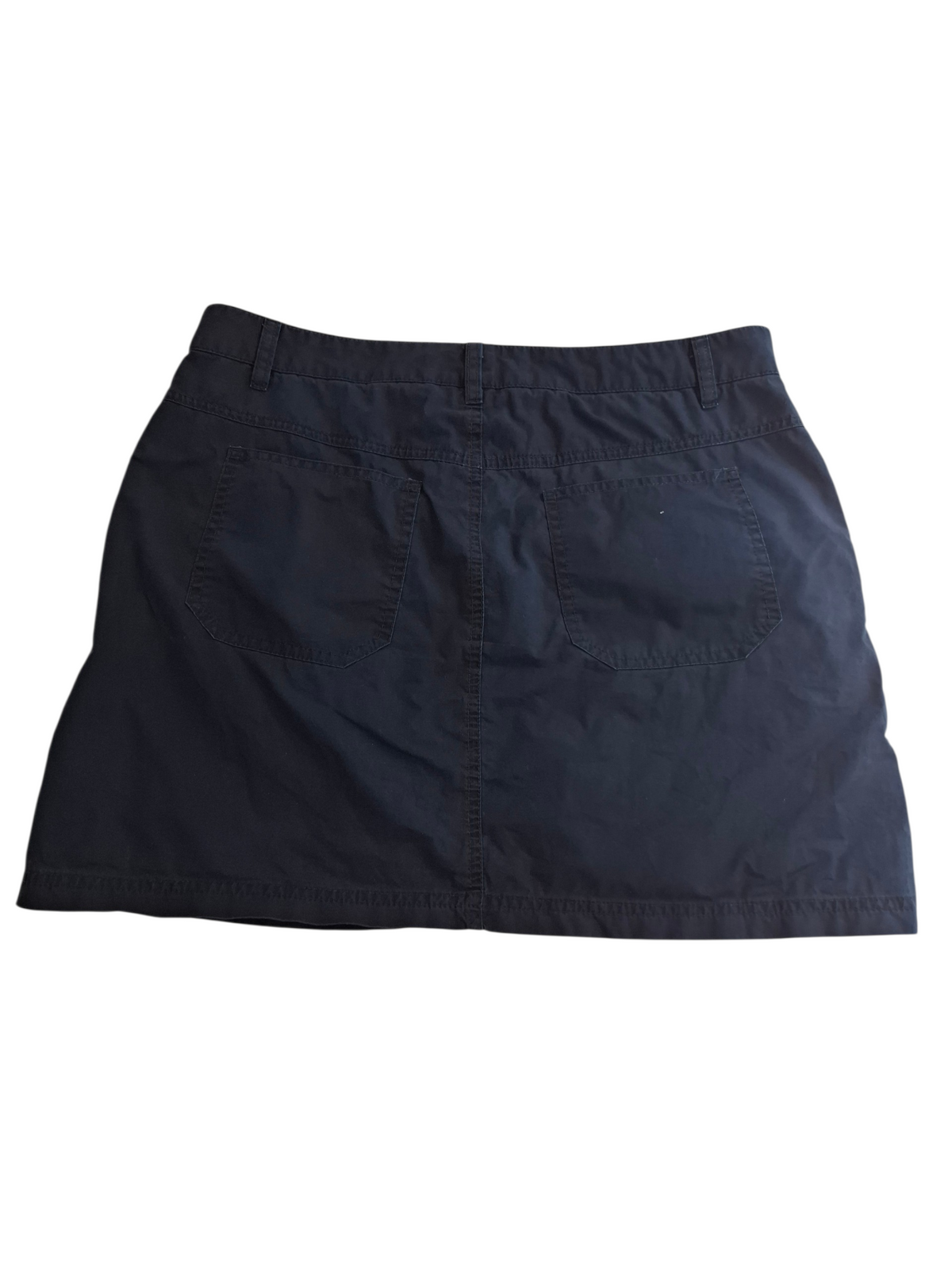 A dark navy blue denim mini skirt shown from the back, featuring two back patch pockets and a button closure, laid flat against a white background.