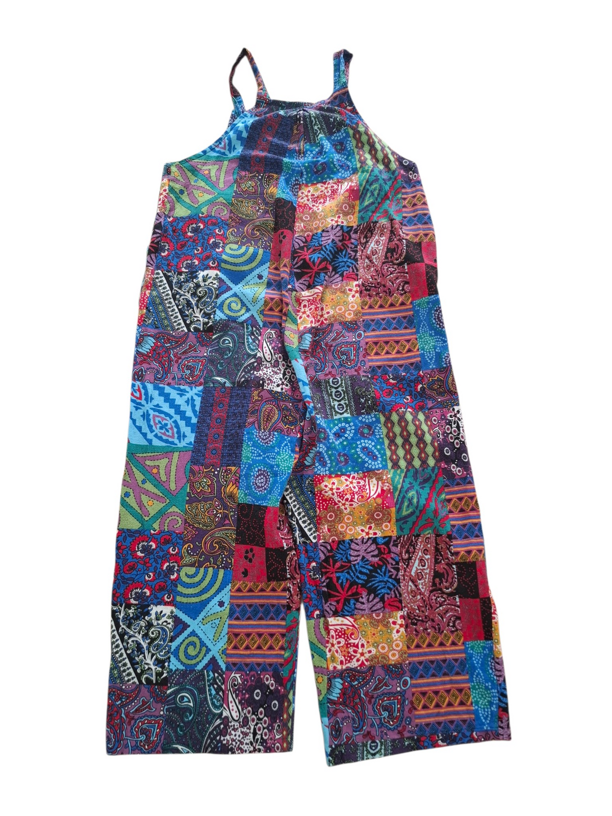 A sleeveless patchwork jumpsuit with a vibrant multicolor print featuring various geometric and paisley patterns in shades of blue, red, pink, orange, and green, shown against a plain white background.