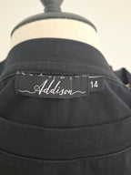 Close-up of a black collared garment on a dress form, showing the Addison brand label and size 14.