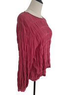 A textured, long-sleeve knit top in a dusty rose or muted magenta color, displayed on a dress form mannequin against a plain white background.