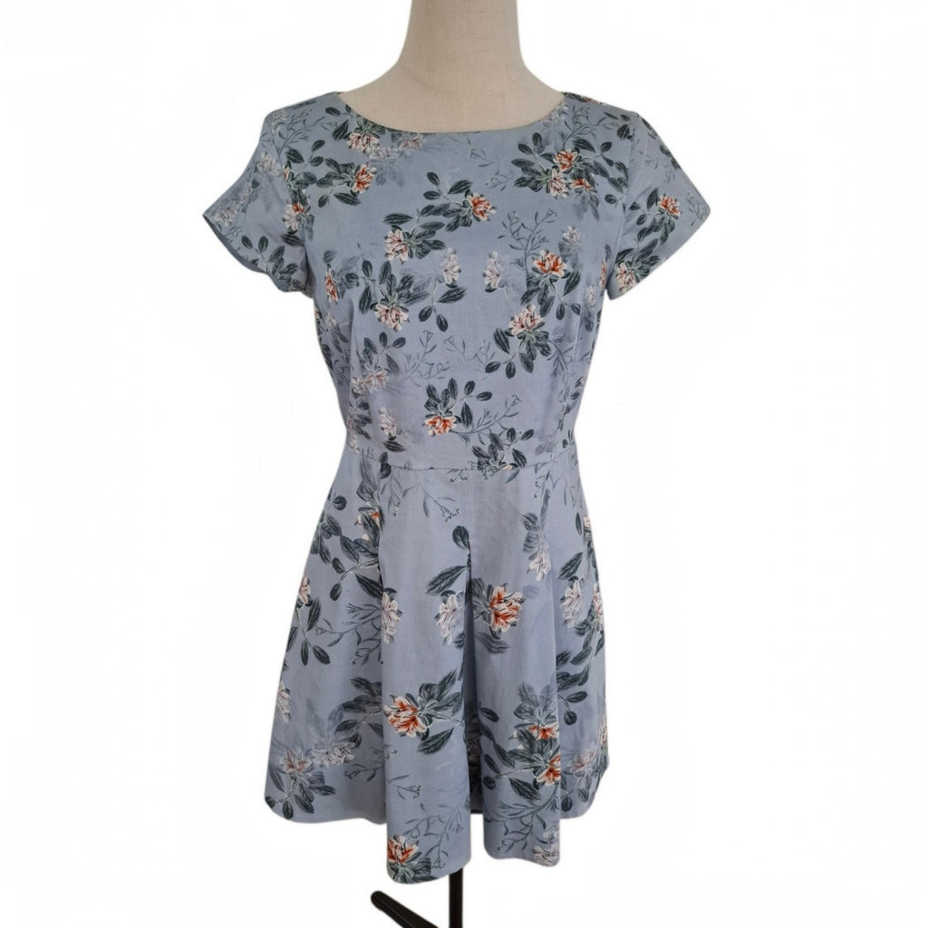 A short-sleeve fit-and-flare dress with a floral print in dusty blue, green, and orange, displayed on a mannequin against a white background.
