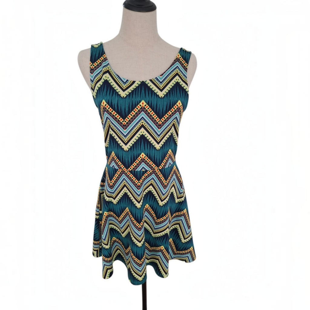 A sleeveless scoop-neck dress with a colorful chevron pattern, displayed on a mannequin torso against a white background.