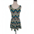 A sleeveless scoop-neck dress with a colorful chevron pattern, displayed on a mannequin torso against a white background.