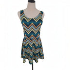 A sleeveless scoop-neck dress with a colorful chevron pattern, displayed on a mannequin torso against a white background.