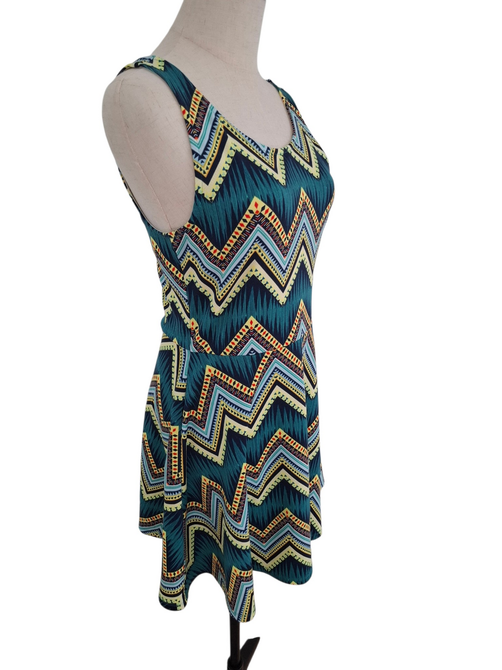 A sleeveless scoop-neck dress with a colorful chevron pattern, displayed on a mannequin against a white background.