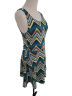 A sleeveless scoop-neck dress with a colorful chevron pattern, displayed on a mannequin against a white background.